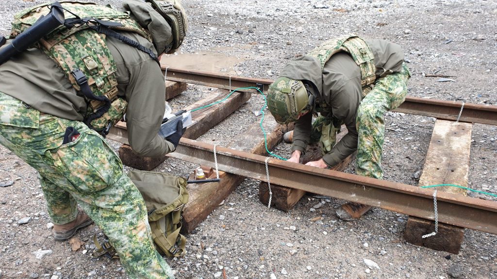 Operators engaged in railway demolition training on an Alford live-fire range