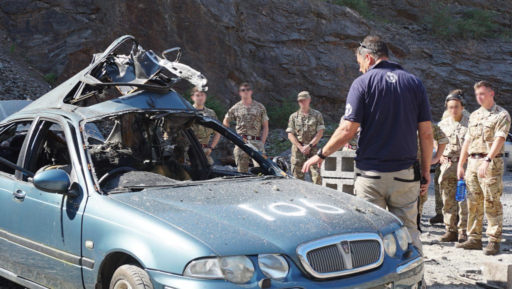Operators assess a target vehicle post-blast during weapons technical intelligence training