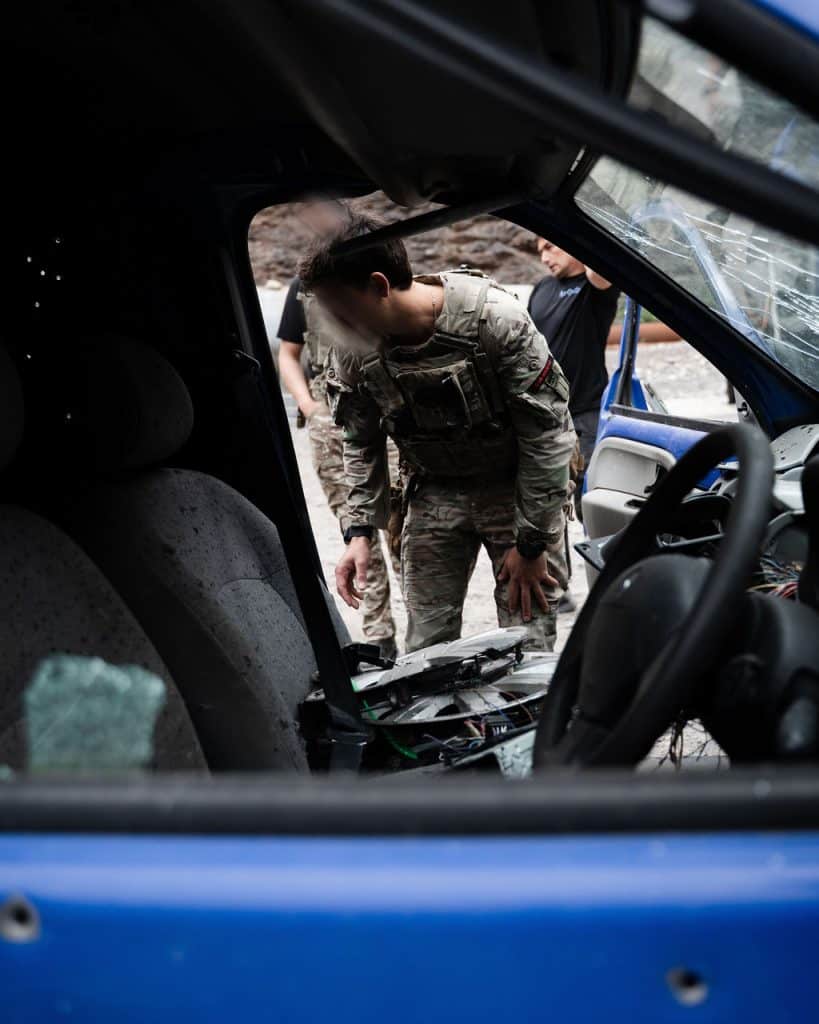 An operator investigating a vehicle post-blast